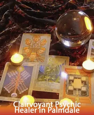 In a serene setting, softly lit by the gentle glow of candles, tarot cards and a crystal ball invite a sense of calm and introspection. Each element whispers ancient wisdom, guiding you on a journey of self-discovery and peace. Clairvoyant psychic healer in Palmdale.