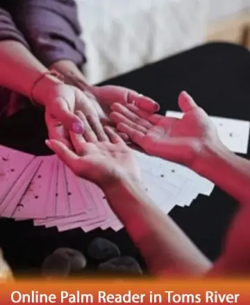 In a serene setting filled with gentle warmth, hands are tenderly extended across a table adorned with delicate cards. This moment captures the timeless exchange of wisdom and insight, nurturing the soul with understanding and peace. Online palm reader in Toms River.