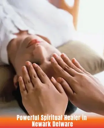 A person lies down with eyes closed, receiving a healing session. Someone's hands hover over their forehead. The setting is calming, with neutral tones, suggesting relaxation and focus.