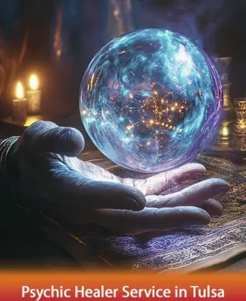 In the gentle glow of candlelight, a hand cradles a mesmerizing crystal ball, shimmering with the mysteries of the universe. This serene image invites you to explore the depths of your soul with warmth and understanding. Psychic healer service in Tulsa.