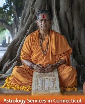 A person in orange robes sits cross-legged under a large tree, looking directly ahead. They hold an open book with Sanskrit text. The setting is serene, with a focus on spirituality.