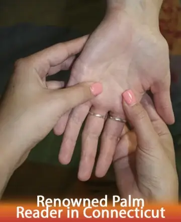 Close-up of two hands: one person gently holds another's palm facing up, examining it. Both have pink nail polish and rings. Text below reads 