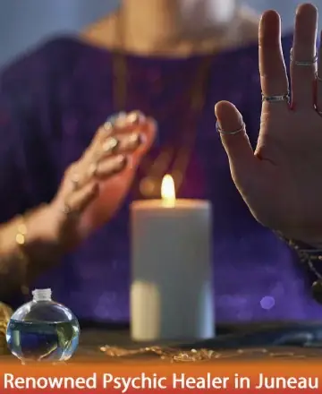 A person wearing rings and purple clothes hovers their hands over a lit candle. A small glass orb and a beaded cloth are visible. The scene is mystical and serene, with warm, dim lighting.