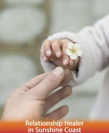 In a tender moment of connection, a small hand offers a delicate flower, symbolizing the gentle exchange of love and trust. This image evokes warmth and the nurturing power of relationships, inviting peace and understanding. Relationship healer in Sunshine Coast.