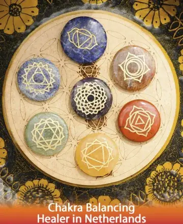 Discover a serene circle of vibrant stones, each adorned with sacred symbols, resting harmoniously on a delicately crafted wooden mandala. This tranquil image invites you to explore the gentle art of chakra balancing, fostering inner peace and spiritual alignment. Chakra balancing healer in Netherlands.
